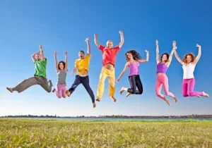 healthygroupjumpingoutdoors